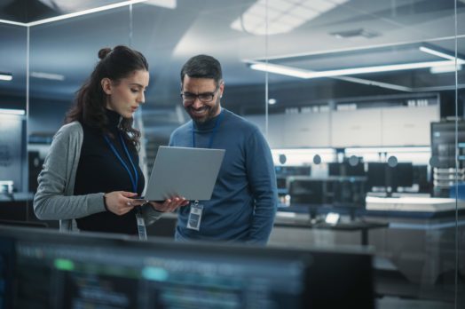 Portrait,Of,Two,Happy,Female,And,Male,Engineers,Using,Laptop